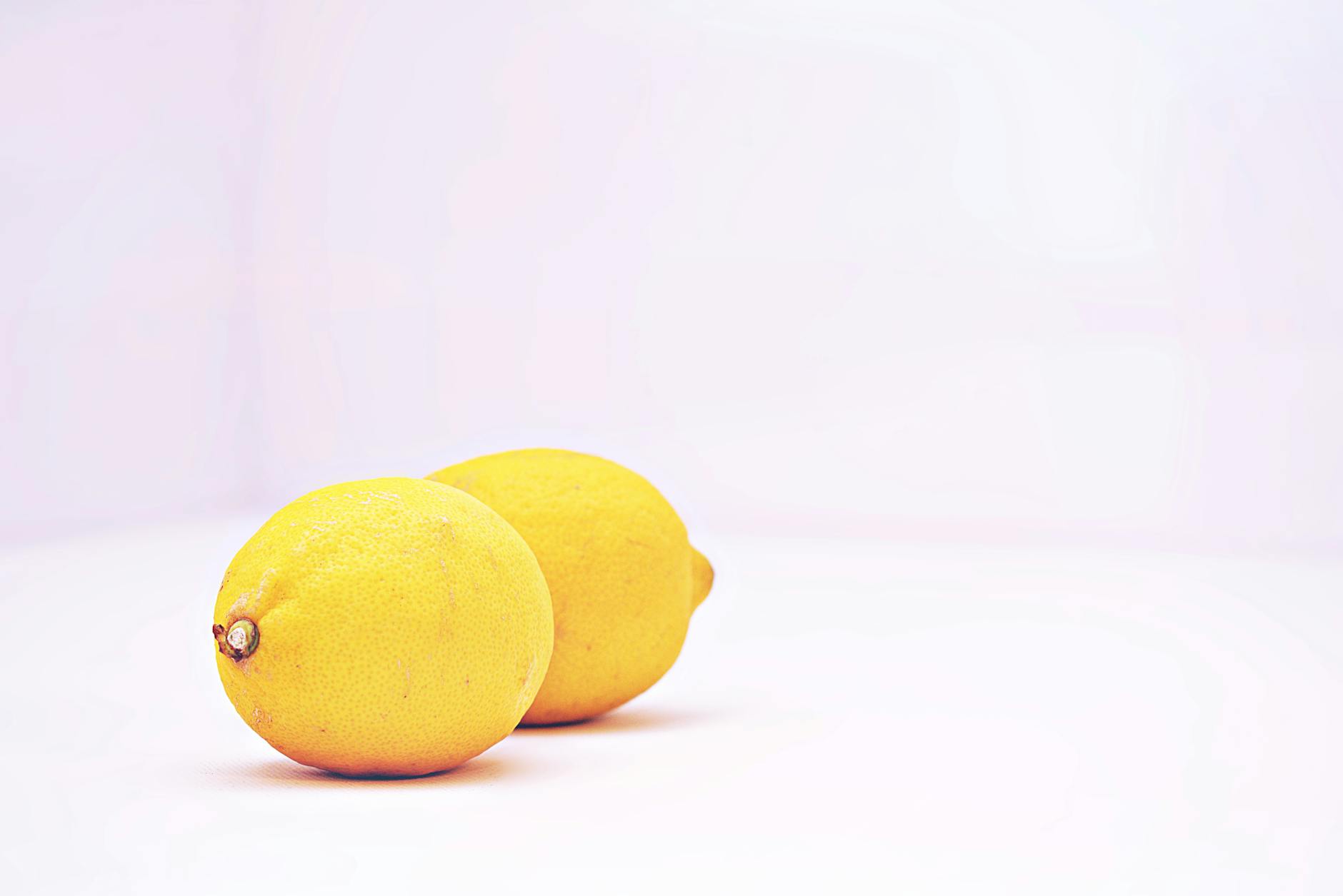 Two bright yellow lemons on a white background, symbolizing a fresh start and sensitivity reset