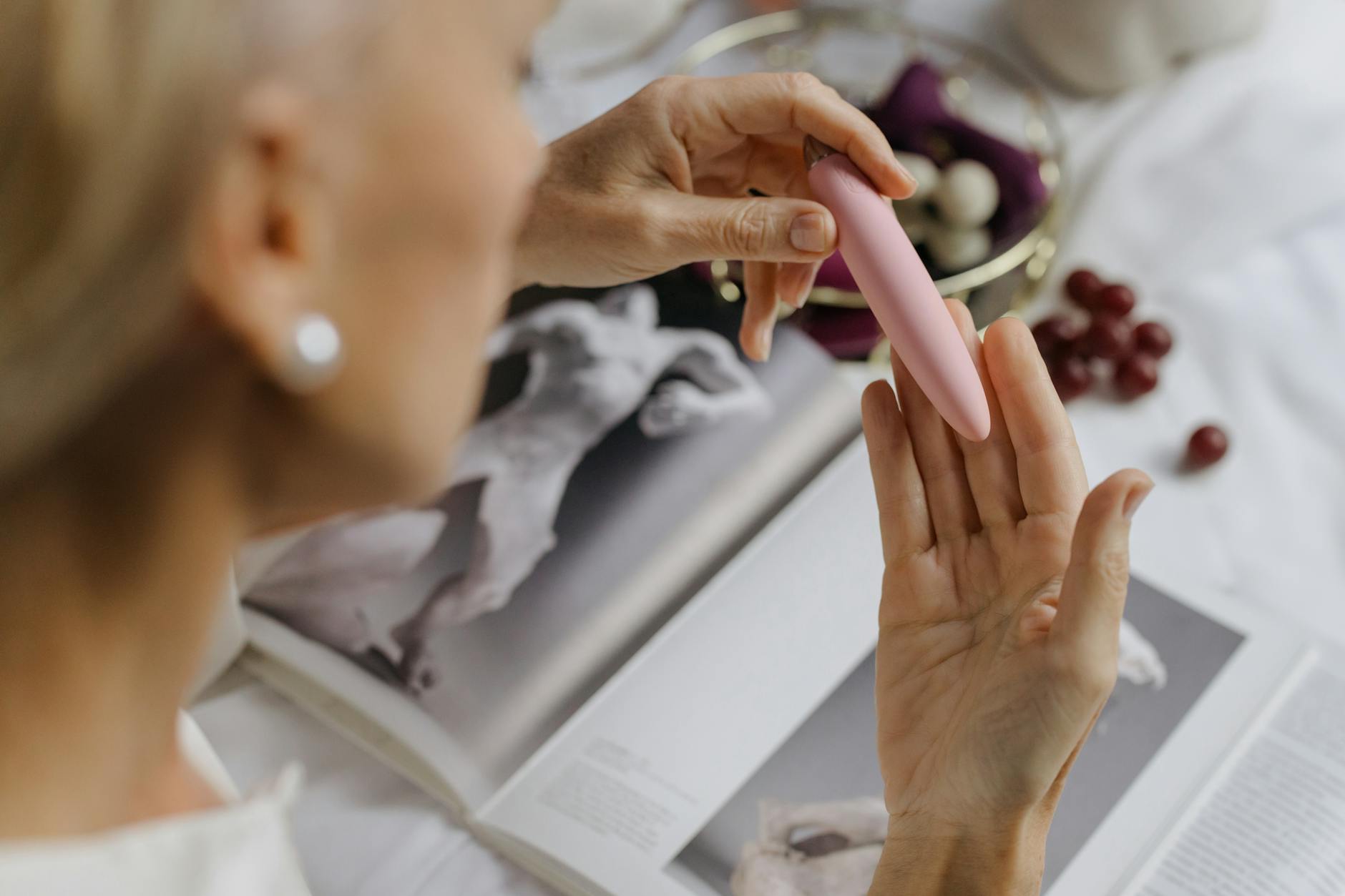 Woman holding colorful vibrators, representing returning to pleasure after a break