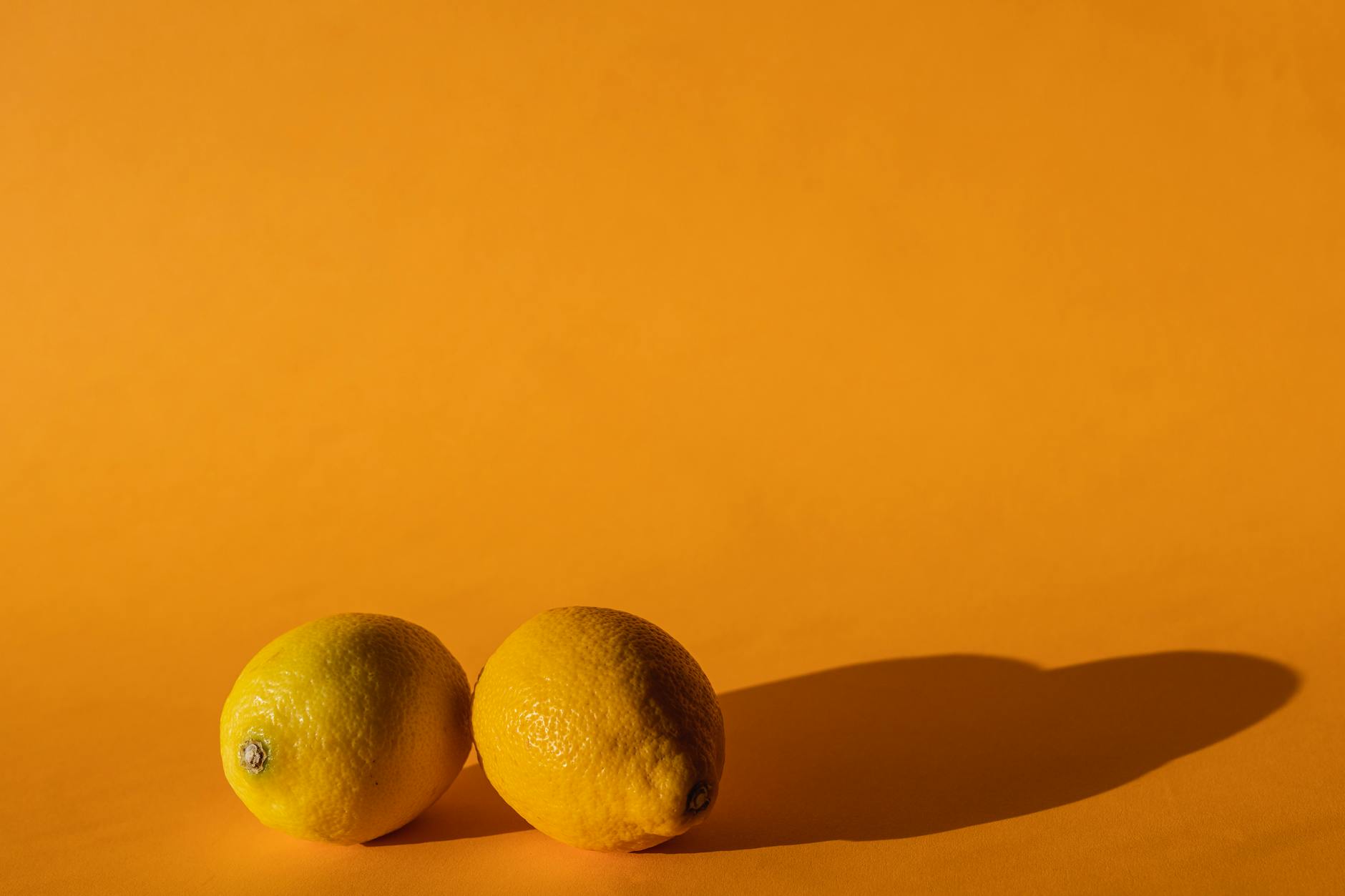 Bright yellow lemons arranged on a sunny background